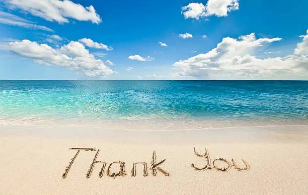 thank you written in the sand on the beach